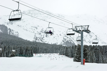 Chairlift with skier at Meribel ski resort, France