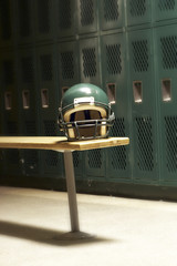 a football helmet on bench in locker room - 8903460