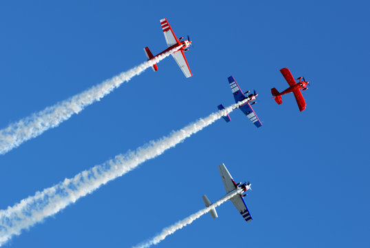 Stunt aircraft in formation, blue sky at air show performance