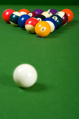 A set of billiards or pool balls on a green felt table