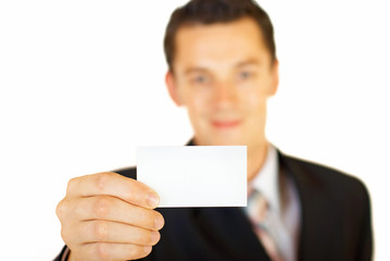 Young businessman holding blank visit card. Backside. Isolated.