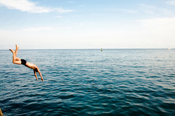 Fototapeta na wymiar An image of men jumping in ocean