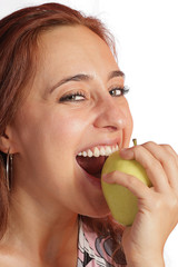Girl is eating a fresh green apple