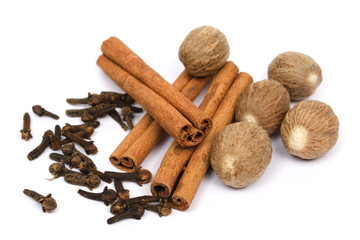 Nutmeg, cinnamon sticks and cloves isolated on white