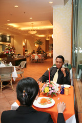 Couple in business suit having dinner in restaurant