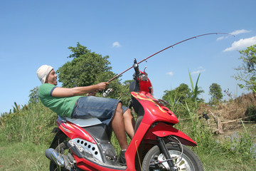 man fishing on motorcycle