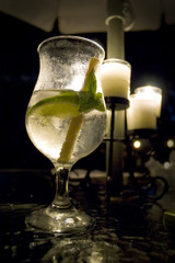 A mojita with mint and a pure sugar cane stirring stick.