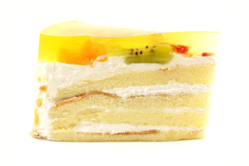 White Sponge Cream Cake With Gelatin Fruit Topping Isolated