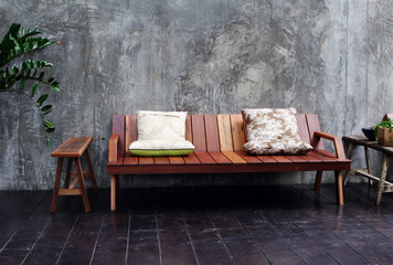 Wooden sofa and cushions in a modern interior.