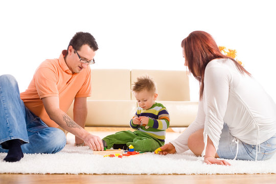 Family with baby boy ( 2 years old ) sitting on floor at home