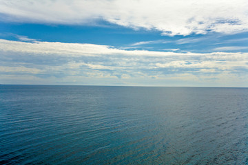 Fototapeta premium image of blue water under the sky with clouds