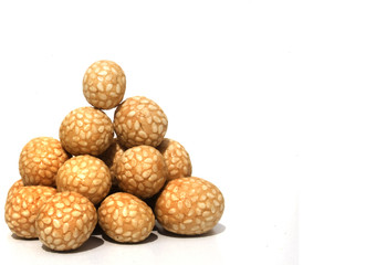 Bowl of Asian rice and sesame crackers against white background