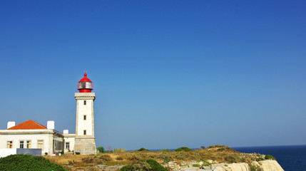 Fototapeta na wymiar Lighthouse in the Portuguese coast, Algarve region.