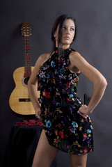beautiful flamenco dancer with black background and guitar.
