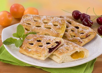 Sweet pastries filled with cherry and apricot jam