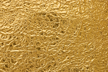 Gold metallic crumpled paper texture for background.