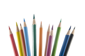 eleven color pencils upright on a white background