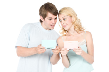 A young couple happily gaming together