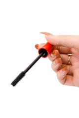 Female hand holding a mascara brush