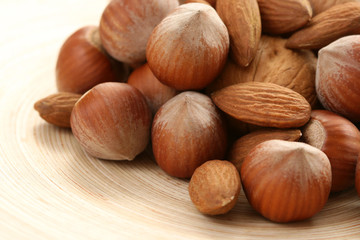 close-ups of hazelnuts and walnuts on wooden table