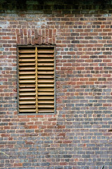 A Slat Window on an old brick mill house
