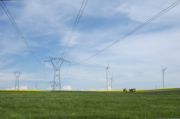 Electric pylons close to windturbines farm France