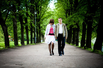 Fototapeta premium Happy young couple walking through valley in park