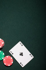 Casino chips on a green background and ace card  in Vegas