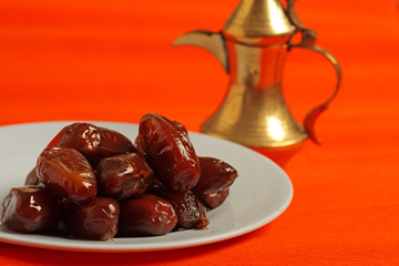 Dates and golden arabic teapot in the background