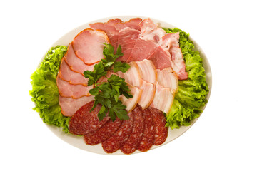 appetizer - ham and sausage with lettuce on the white plate