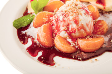 fresh juicy fruits with icecream on plate