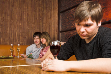 Three young people spend time in cafe