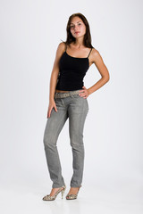 Young brunette woman in a black shirt and grey jeans