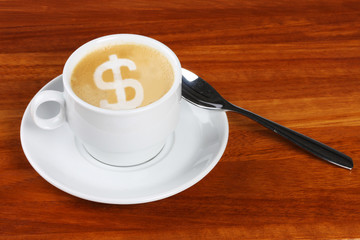 Cup of coffee with dollar sign made in frothing milk