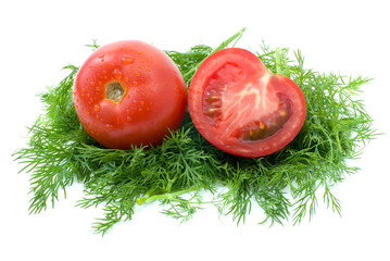 Whole and half of tomato over dill isolated on the white