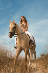 Young female riding on horse
