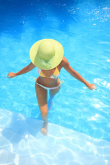 Young woman standing  in a swimming pool