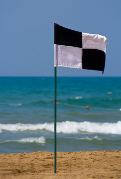 Quartered black and white flag on the beach