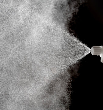 Water spraying from a spray bottle nozzle