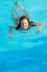 Fototapeta na wymiar Girl Swimming Underwater