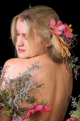 Naklejka premium Beautiful young blond model with flowers in her hair