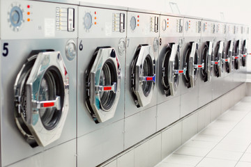 A row of industrial washing machines