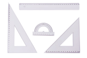 Ruler, squares and a protactor on a white background.
