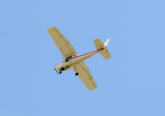 Light private airplane passing overhead