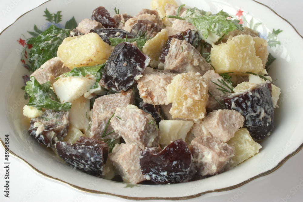 Wall mural Salad with meat, a boiled potato, boiled eggs and prunes