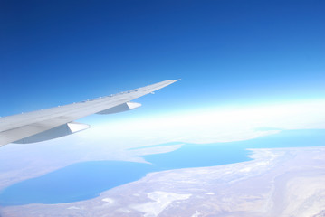 Plane wing against blue sky