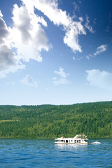 Fototapeta na wymiar A luxury house boat on a lake in the summer