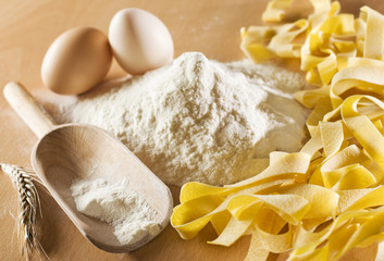 Fresh pasta with flour and egg close up