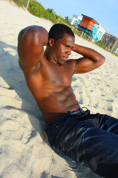 Man doing crunches on the beach