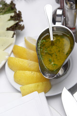 Seasoning to fish food - a lemon, cheese, greens and sauce.